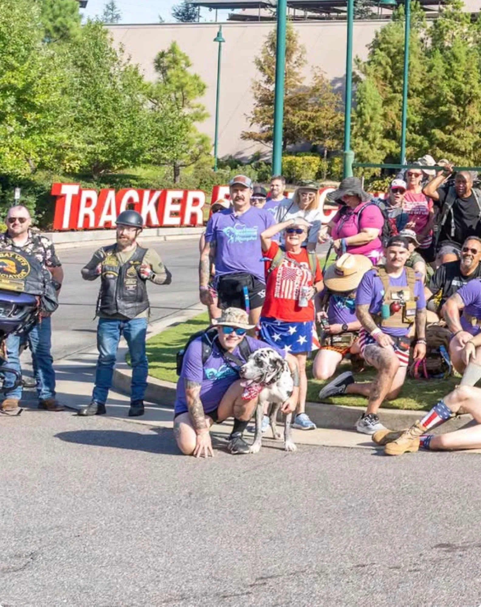 Riders, families, and a spotted dog gathered at a community ride