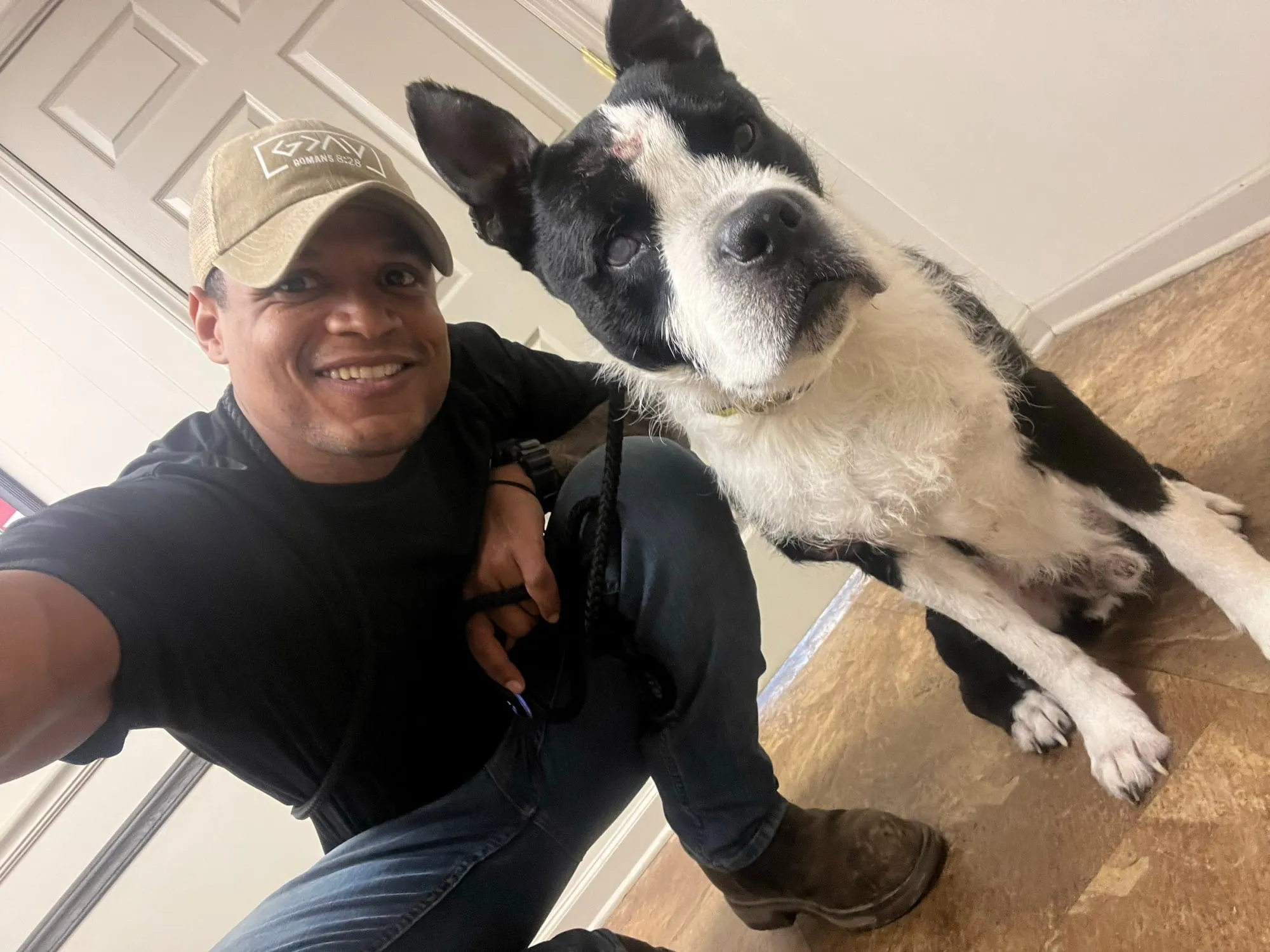 Josh grinning with a black and white border collie mix